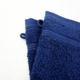 Gants de toilette bleu marine en éponge bouclette, doux et ultra-absorbants, 100% coton parfaits pour un soin quotidien du visage et du corps.