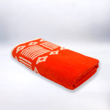 serviette de plage éponge velours jacquard oranza orange 90x170 400g/m² douce, absorbante et élégante parfaite pour plage et piscine.