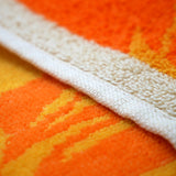 zoom serviette de plage éponge velours Jacquard Frutti Orange 90x170cm 400g/m² douce, absorbante et élégante, parfaite pour plage et piscine.