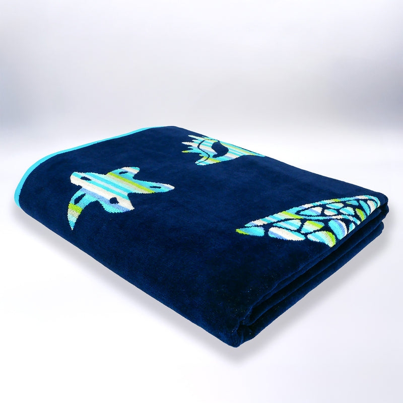 Serviette de plage XL pliée velours Jacquard bleu Calypso - Le Comptoir de la Plage