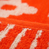zoom serviette de plage éponge velours jacquard oranza orange 90x170cm 400g/m² douce, absorbante et élégante parfaite pour plage et piscine.
