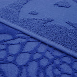 zoom serviette de plage éponge velours jacquard unie ciselés Kelly Bleu 90x170 340g/m² douce et absorbante, idéale piscine, plage ou salle de bain