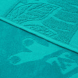 zoom serviette de plage éponge velours jacquard unis ciselés kariba bleu 90x170 340g/m² douce et absorbante, idéale piscine, plage ou salle de bain.